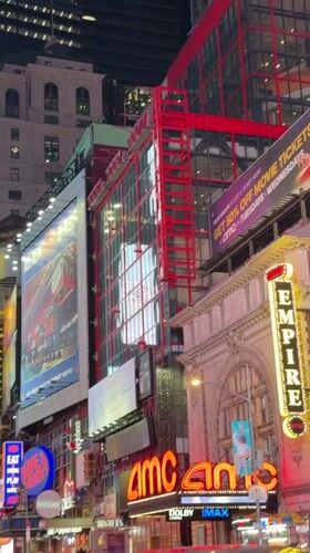 Times Square blazes with neon signs and billboard ads at night