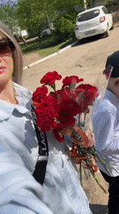 Woman carries Victory Day carnations in Chaikovsky, Russia