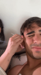 Woman assists man with ear cleaning in Sarandí home