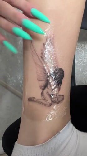 Fresh winged woman ankle tattoo documented in Abakan