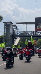 Motorcycle procession with decorated vehicles parades through Surabaya streets
