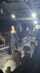 Fashion show features models in designer dresses on runway