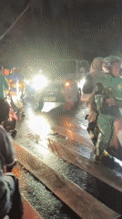 Night traffic moves through flooded Depok streets after rainfall