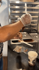 Woman decorates desserts at chocolate shop during morning hours