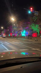 Nighttime traffic captured on tree-lined Moscow street