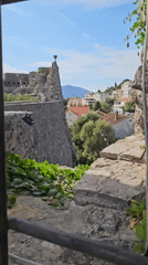 Stone fortress in Herceg Novi, framed by climbing vines