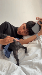 Man and dressed dog rest indoors in Quy Nhon