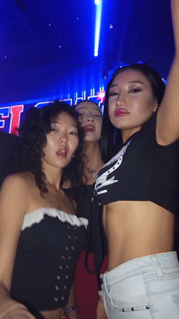 Nightclub scene with DJ performance and dancing crowds