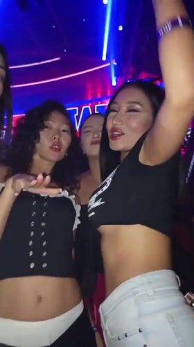 Nightclub scene with DJ performance and dancing crowds