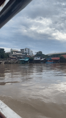 Passenger boats on a muddy Davao City river crossing