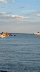 Calm waters and rocky island filmed near Bečići, Montenegro