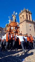Religious procession with ornate bishop float observed in Cuzco