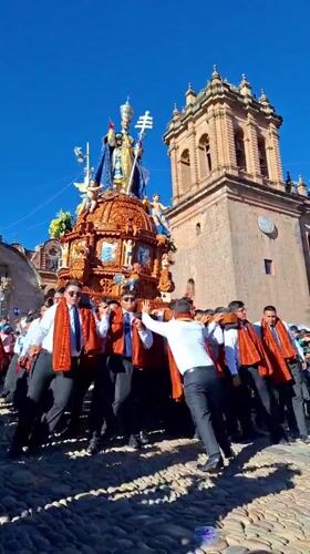 Religious procession with ornate bishop float observed in Cuzco