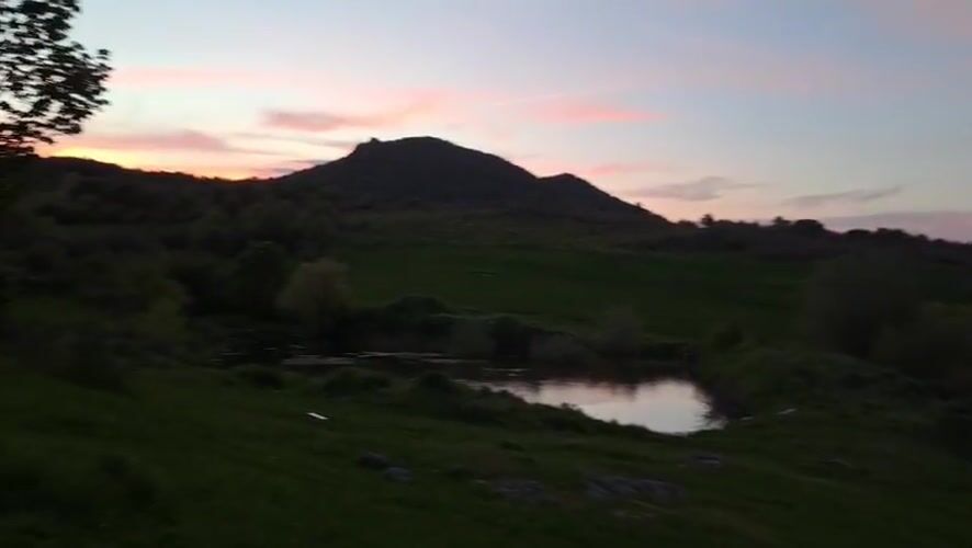 Rural sunset scene with pond captured near Bryastovo, Bulgaria