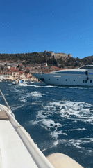 Boating through Hvar harbor on a clear summer morning