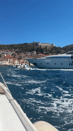 Boating through Hvar harbor on a clear summer morning