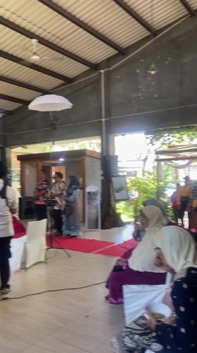 Wedding guests dance at outdoor celebration in Sidoarjo, Indonesia