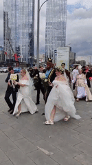 Brass band plays riverside as wedding parties gather in Moscow