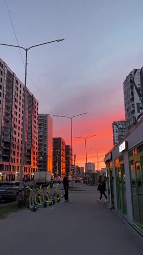 Dramatic sunset colors illuminate Kudrovo residential district at twilight