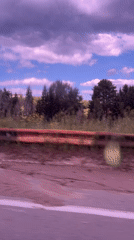 Rural landscape with purple clouds recorded from vehicle in Russia