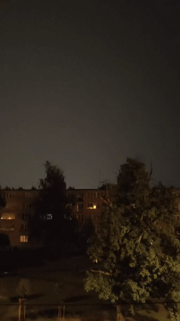 Bright flash of light near an apartment building at night