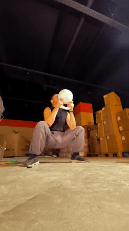 Kettlebell training in a dim warehouse gym, Karaganda