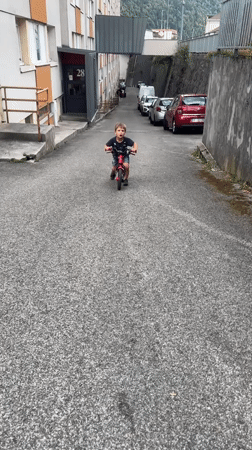 Kids play and ride bikes at a casual Saint-Claude outdoor gathering