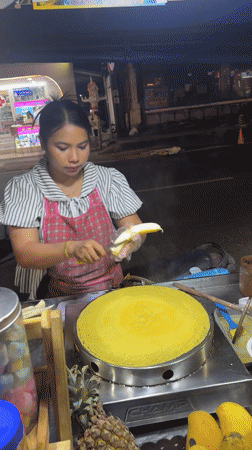 Street vendor prepares banana crepes at Patong night market