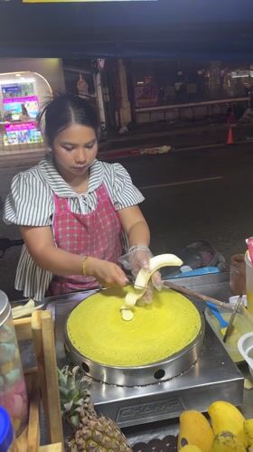 Street vendor prepares banana crepes at Patong night market