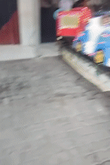 Kids' carousel rides and street traffic in Pisangan Jaya