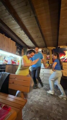 Group Dancing Celebration in Bulgarian Mountain Cabin