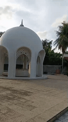 White domed structure with spire documented in Indonesia