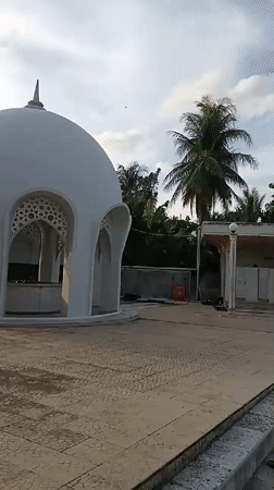White domed structure with spire documented in Indonesia
