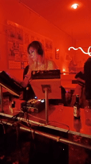 Musicians perform at red-lit North Kuta bar venue
