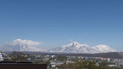 Clear skies reveal Petropavlovsk-Kamchatsky beneath snow-capped volcanoes