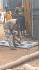 Metal workers cut gates with grinders in Akwanga