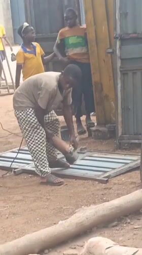 Metal workers cut gates with grinders in Akwanga