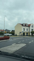 Vehicle records drive through Wilamowice featuring ornate church spire
