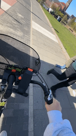 Cyclist in white hoodie recorded during morning ride in Kiel