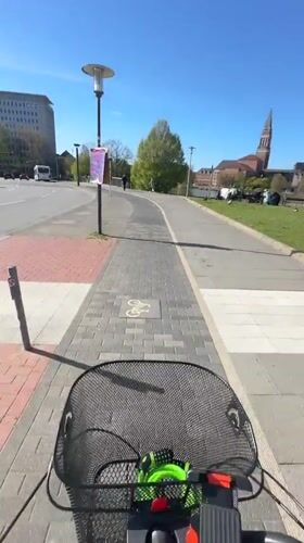 Cyclist in white hoodie recorded during morning ride in Kiel