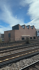 Train passenger films industrial railway view in sunny London