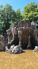 Rocky cave fountain with carved face in Pyatigorsk park