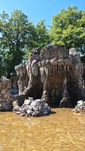 Rocky cave fountain with carved face in Pyatigorsk park