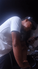 Person checks phone while seated in Juan Griego, Venezuela