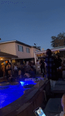Late-night pool party in a Cypress backyard, blue lights and balloons