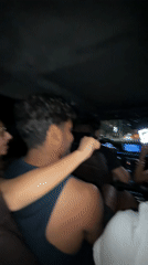 Four people travel together in car at night