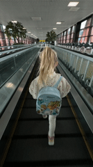 Young girl with backpack walks through Khimki airport