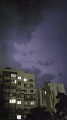 Lightning storm over Brest apartment blocks, August night