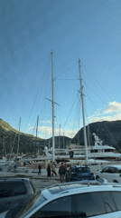 Vehicle captures Kotor harbor scene with yachts and sailboats