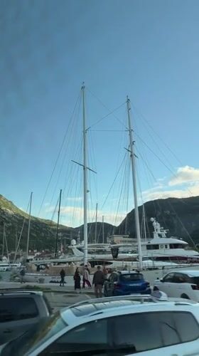 Vehicle captures Kotor harbor scene with yachts and sailboats
